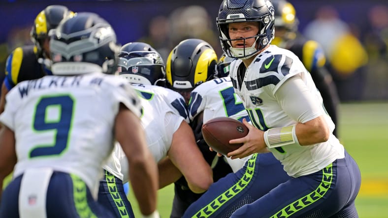 Sam Darnold readies a handoff against the Rams at SoFi Stadium.