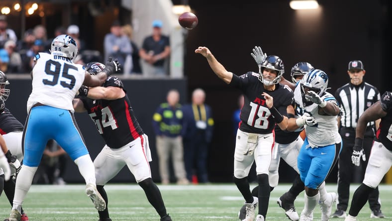 Kirk Cousins throws under pressure against the Panthers in Atlanta.