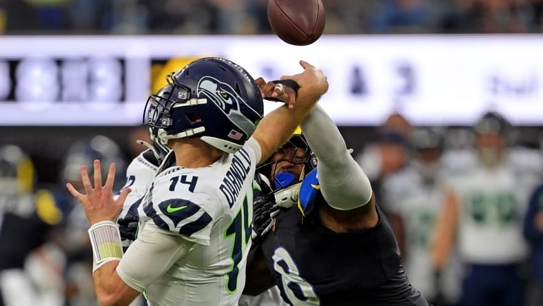 Jared Verse knocks the ball away from Sam Darnold at SoFi Stadium.