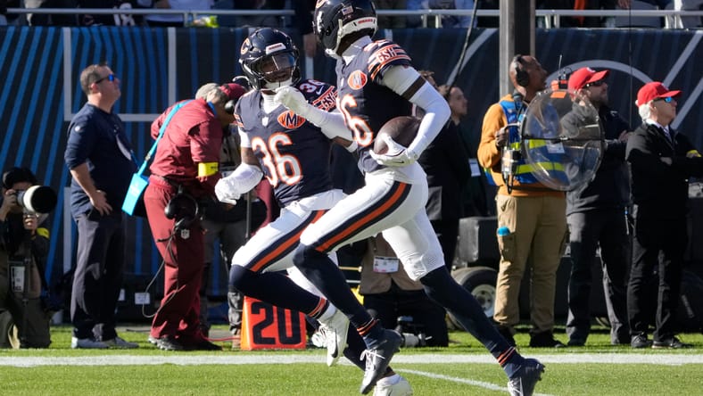 Nahshon Wright and Jonathan Owens celebrate an interception.
