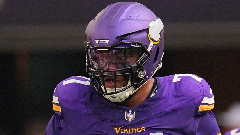 Christian Darrisaw prepares for a snap during first-half action at U.S. Bank Stadium.