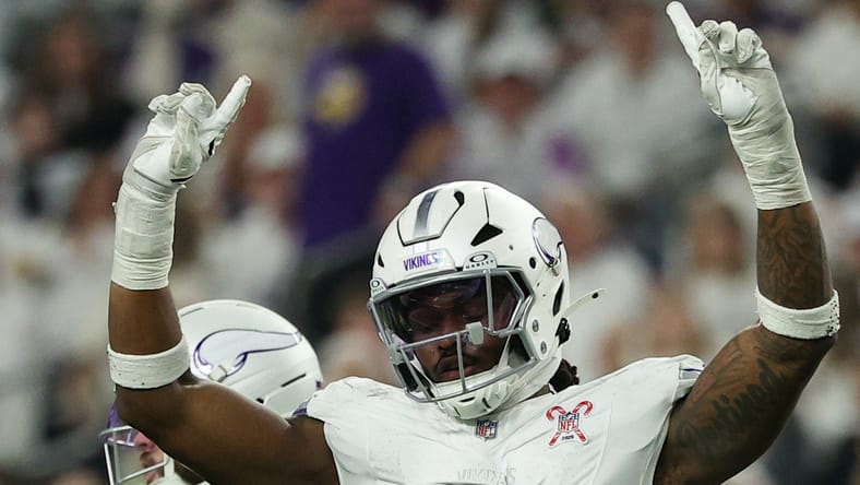 Vikings linebacker Dallas Turner celebrates while Lions quarterback Jared Goff reacts after a defensive play at U.S. Bank Stadium.