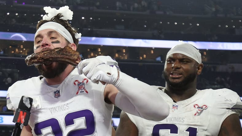 Harrison Smith eats a steak while being interviewed by Dianna Russini on the field at U.S. Bank Stadium after a Vikings game.