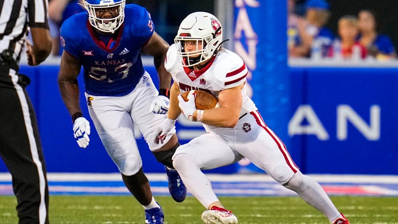 Travis Theis runs through defenders against Kansas.