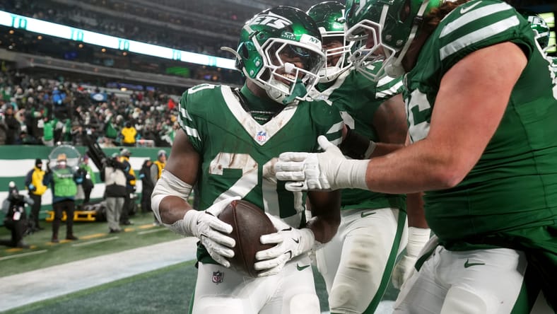 Breece Hall celebrating with Jets teammates after a fourth-quarter touchdown. Vikings rumors Breece Hall