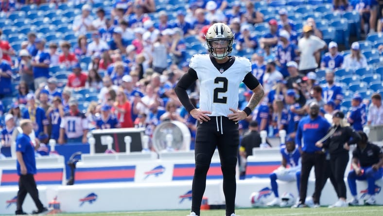 Spencer Rattler warms up on the field before the Saints face the Bills. Rattler became part of Vikings rumors in 2025.