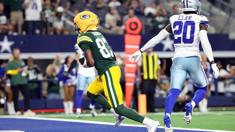Romeo Doubs scores a touchdown against the Cowboys at AT&T Stadium.