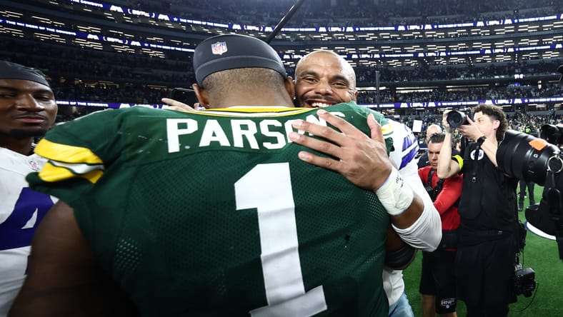 Micah Parsons and Dak Prescott embrace after a game at AT&T Stadium. Vikings playoff chances.
