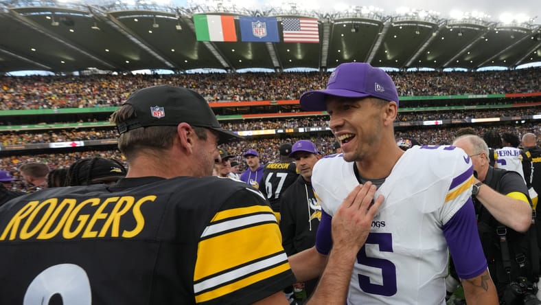 Aaron Rodgers and Desmond Ridder talk on the field after the Dublin game.