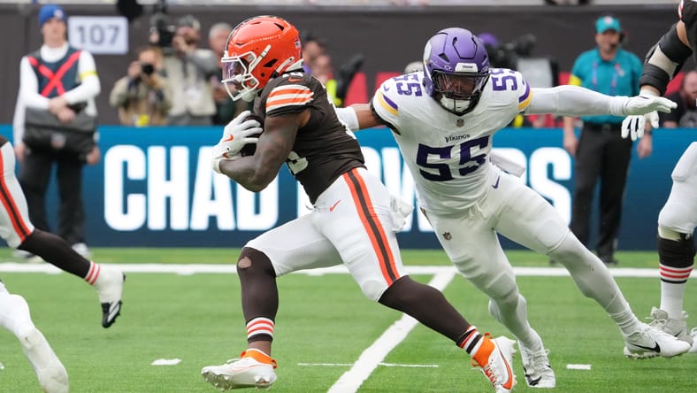 Quinshon Judkins carries the ball as Eric Wilson pursues during the Browns–Vikings game in London.