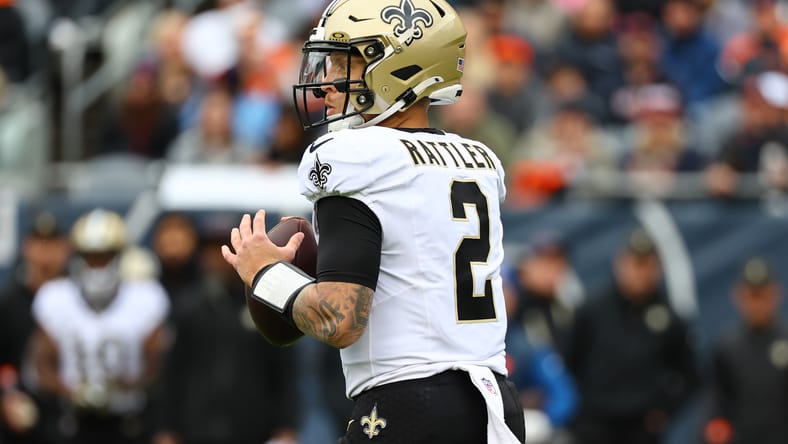 Spencer Rattler drops back to pass during a Saints game against the Bears. Vikings quarterback predictions.