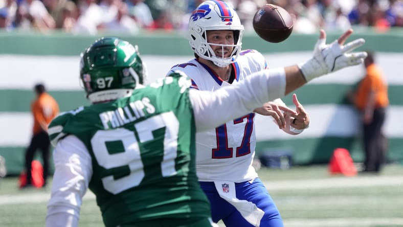 Josh Allen fires a pass as Harrison Phillips closes in at MetLife Stadium.