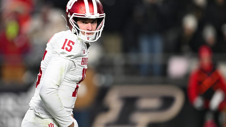 Fernando Mendoza watches from the sideline during the Indiana–Purdue matchup.