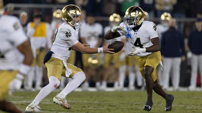 CJ Carr hands off to Jeremiyah Love during Notre Dame’s game at Stanford Stadium. Jeremiyah Love declares for NFL Draft.