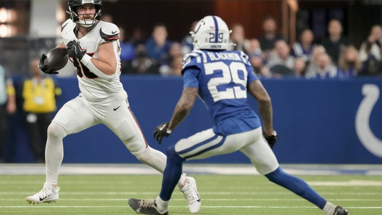 Mekhi Blackmon chases Dalton Schultz during Colts–Texans action at Lucas Oil Stadium.