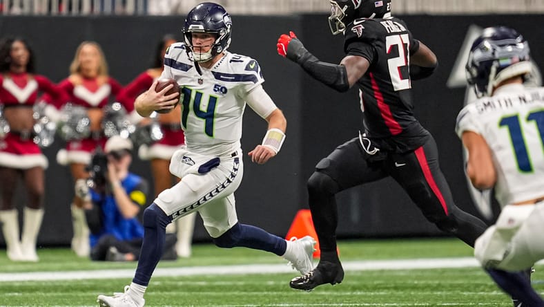 Sam Darnold scrambles as James Pearce Jr. closes in.