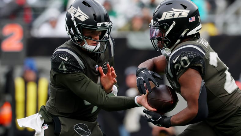 Brady Cook hands the ball to Breece Hall during the first half at MetLife Stadium.