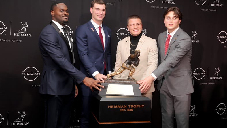 Jeremiyah Love poses with the Heisman Trophy during a press conference in New York.