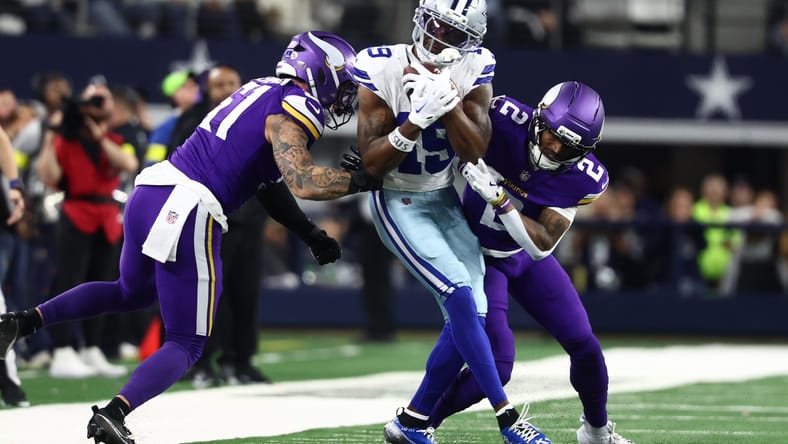 Blake Cashman and Isaiah Rodgers tackle Cowboys wide receiver Ryan Flournoy at AT&T Stadium. Vikings touchdown passes allowed streak.