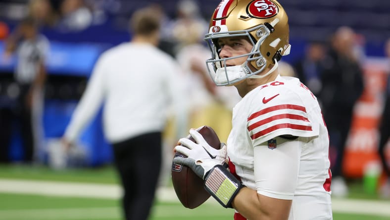 Mac Jones warms up before a 49ers game at Lucas Oil Stadium.