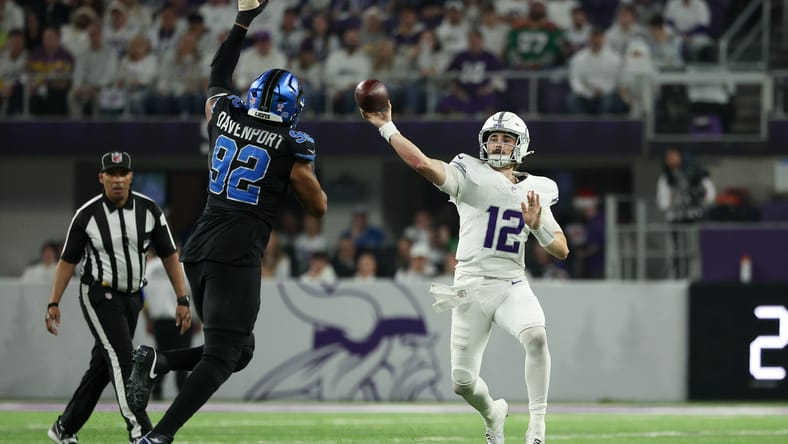 Vikings quarterback Max Brosmer throws while being pressured by Lions defensive end Marcus Davenport at U.S. Bank Stadium. Vikings vs Lions Christmas Day.