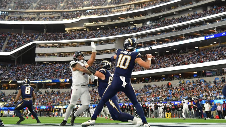 Justin Herbert drops back to pass from the pocket against the Texans at SoFi Stadium.