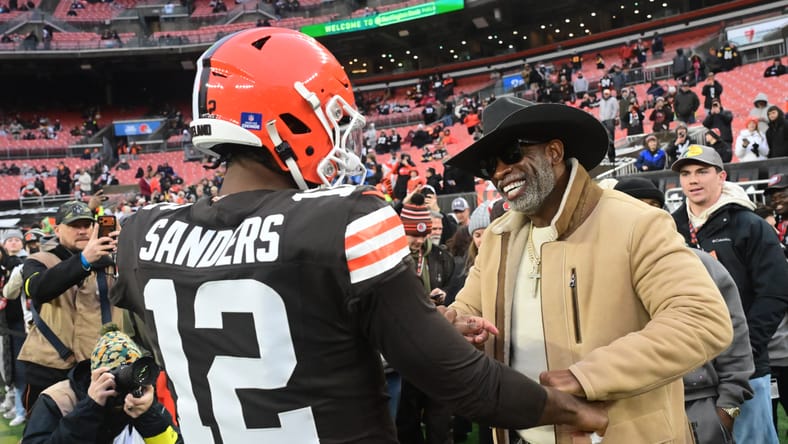 Shedeur Sanders stands with Deion Sanders on the Browns sideline before a game. Vikings could have drafted Shedeur Sanders.
