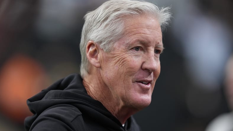 Pete Carroll observes Raiders warmups before a home game at Allegiant Stadium. Ex-Vikings Coaches Hot Seat.