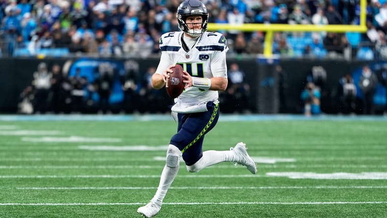 Sam Darnold rolls right and prepares to throw while scrambling against the Panthers. Sam Darnold Seahawks Week 18.