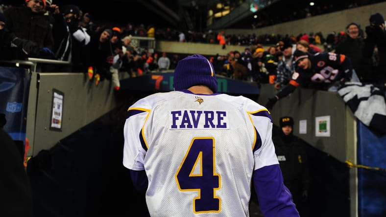 Brett Favre walks off Soldier Field after the overtime loss to Chicago.