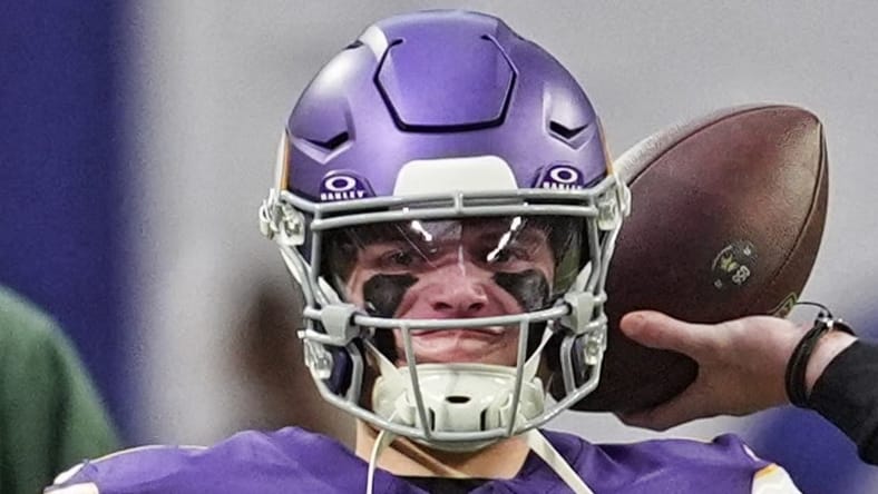 Vikings quarterback J.J. McCarthy warming up on the field at U.S. Bank Stadium.