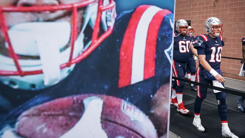 Mac Jones walking onto the field at Gillette Stadium before a Patriots game. Vikings trade for Mac Jones.
