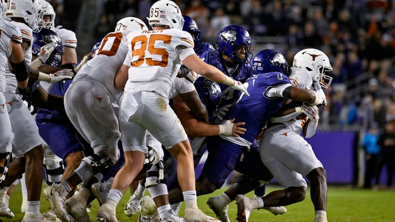 CJ Baxter being tackled by a TCU defender