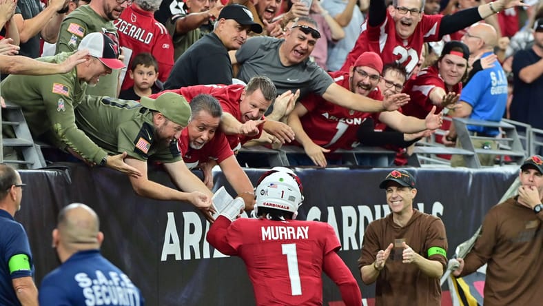 Kyler Murray celebrating with fans after a touchdown.