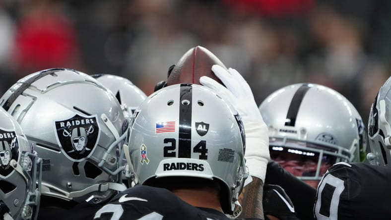 A Las Vegas Raiders huddle in 2023.