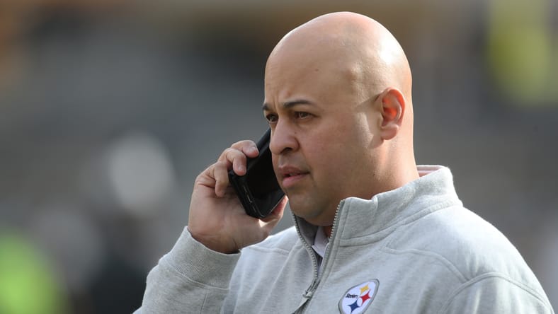 Steelers general manager Omar Khan talking on the phone before a game in Pittsburgh.