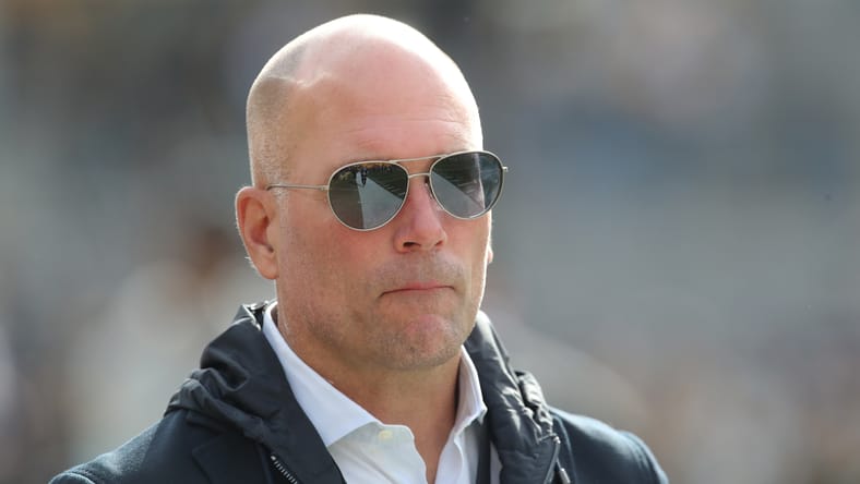 Eric DeCosta watches warmups before a Ravens game in Pittsburgh.