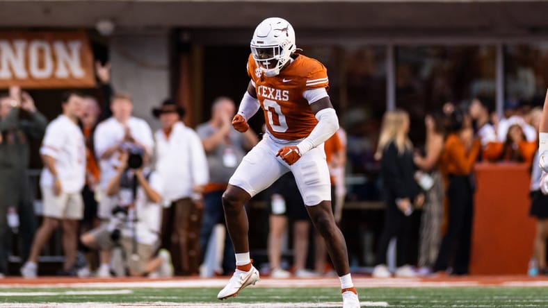 Anthony Hill Jr. celebrates a sack during a Texas Longhorns game against Kentucky. Vikings Jake Golday.