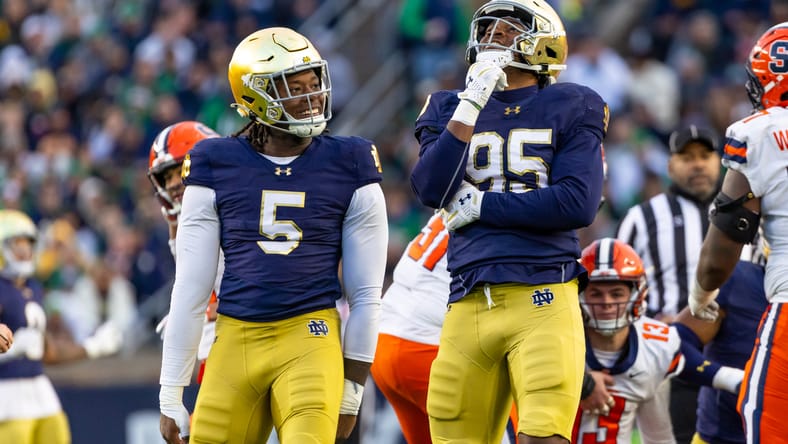 Notre Dame defensive lineman Bryce Young celebrates with Boubacar Traore after a stop against Syracuse.