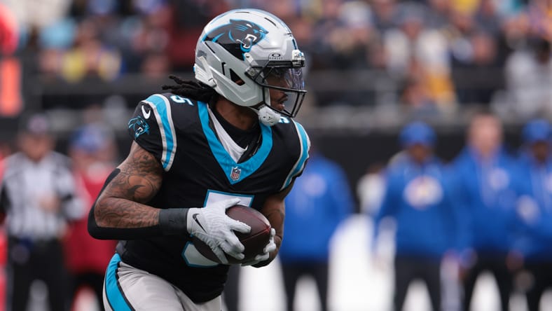 Rico Dowdle rushing against the Los Angeles Rams at Bank of America Stadium.