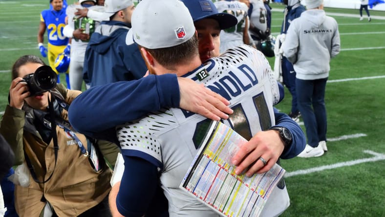 Sam Darnold hugs Seahawks offensive coordinator Klint Kubiak after an overtime win.