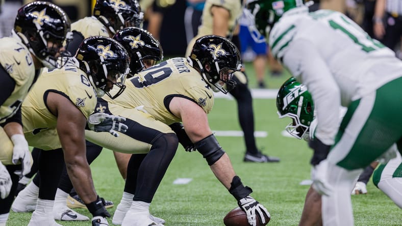 Saints center Luke Fortner hikes the ball during a game.