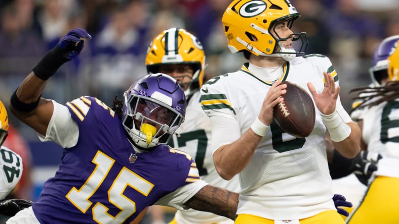 Dallas Turner pressures Clayton Tune during a first-quarter play at U.S. Bank Stadium.
