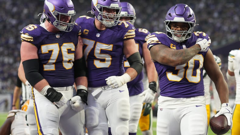 Will Fries, Brian O’Neill, and C.J. Ham celebrate a Vikings touchdown at U.S. Bank Stadium.