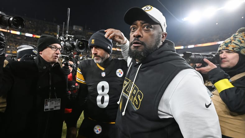 Mike Tomlin celebrates with Aaron Rodgers after a win at Acrisure Stadium.