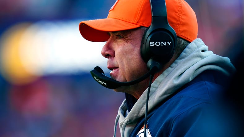 Sean Payton stands on the Broncos sideline during a playoff game.