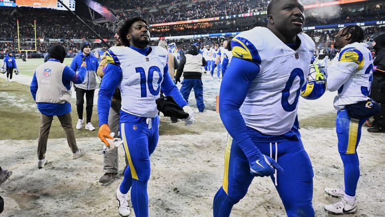 Rams linebackers Josaiah Stewart and Byron Young leave the field after a playoff game in Chicago.