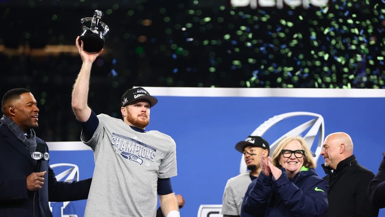 Sam Darnold celebrating with the NFC Championship trophy