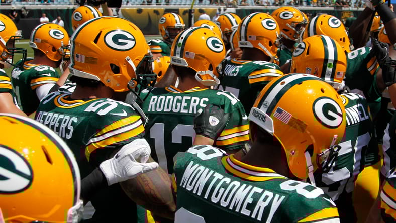 Aaron Rodgers leads a Packers huddle before a road game in Jacksonville. Aaron Rodgers Vikings rumors.
