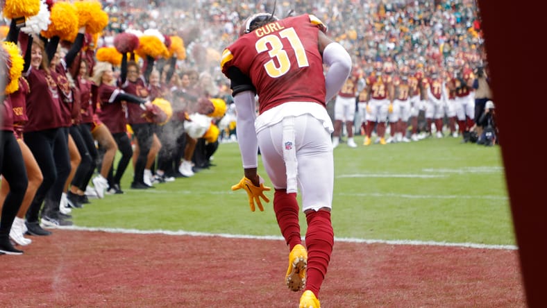 Kamren Curl runs onto the field during pregame introductions at FedExField. Vikings rumors.